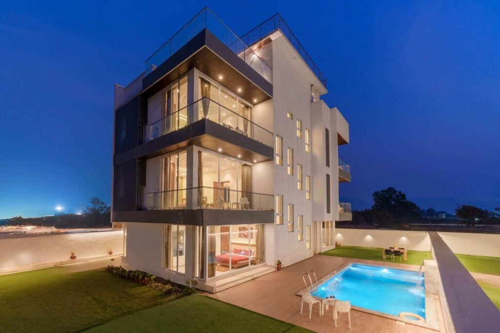 Modern home and pool illuminated at twilight
